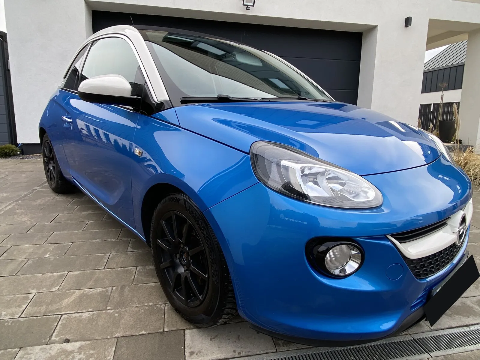 Niebieski Opel Adam z białym dachem po detailingu, ujęcie z przodu